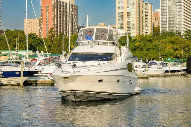 Slide: The Image of 2003 Silverton 410 Sport Bridge yacht docked in urban marina setting. - 5