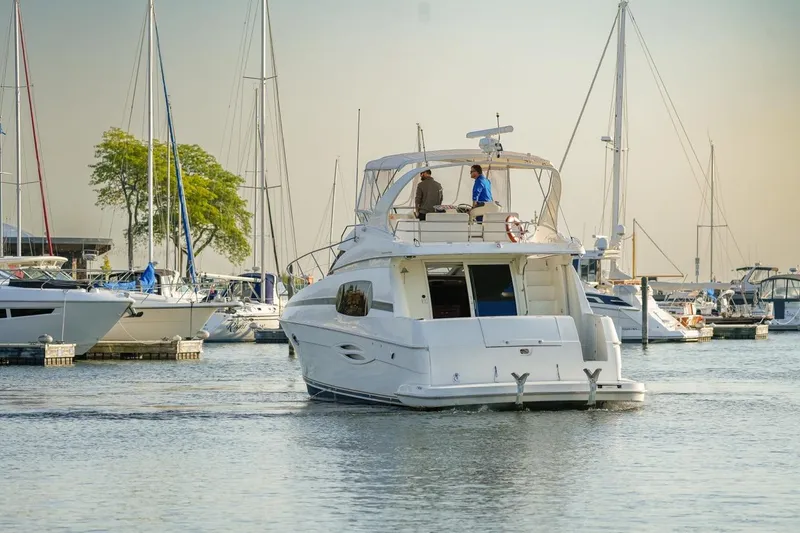 Slide: The Image of 2003 Silverton 410 Sport Bridge yacht in a marina, surrounded by sailboats. - 55