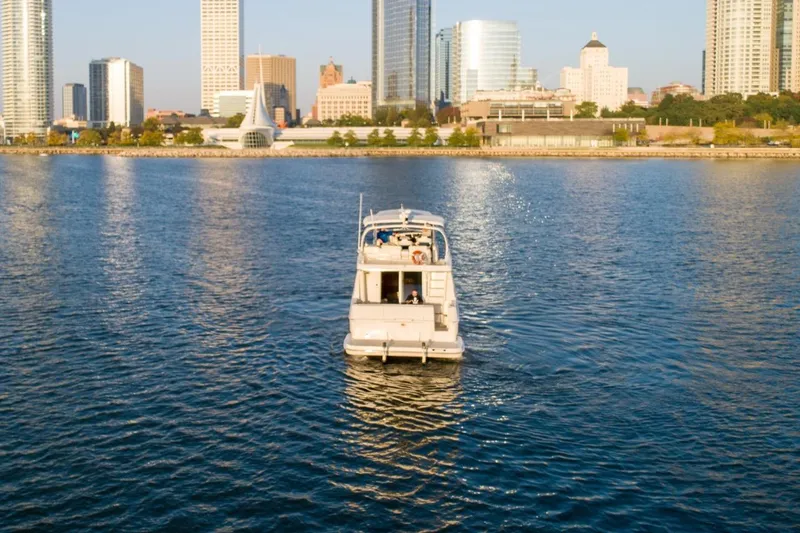 Slide: The Image of 2003 Silverton 410 Sport Bridge yacht cruising near city skyline. - 69