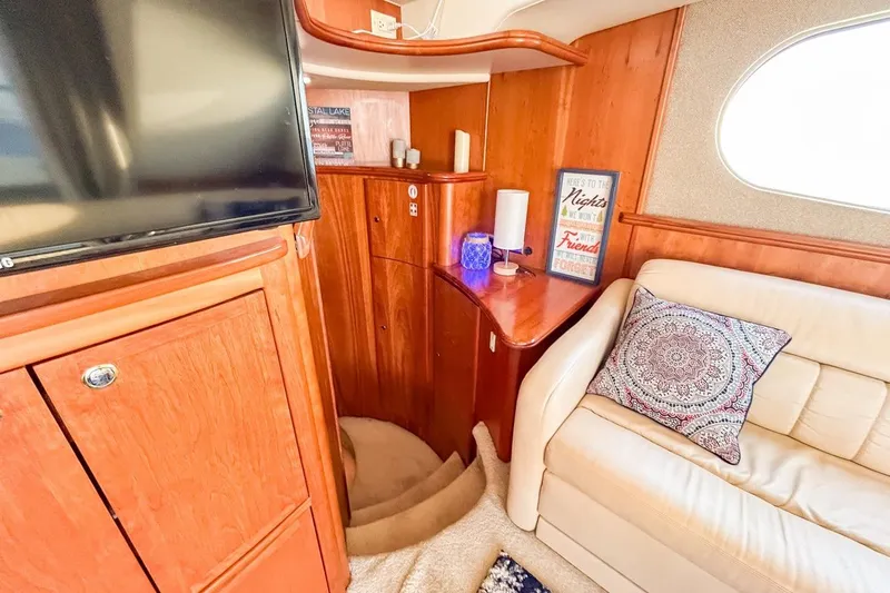 Slide: The Image of Interior of 2003 Silverton 410 Sport Bridge with cozy seating and wooden cabinetry. - 88