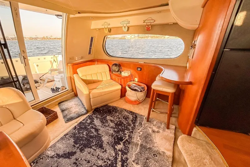 Slide: The Image of Interior of 2003 Silverton 410 Sport Bridge yacht with cozy seating and waterfront view. - 89