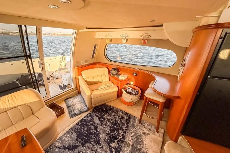 Slide: The Image of Interior of 2003 Silverton 410 Sport Bridge yacht with cozy seating and ocean view. - 90