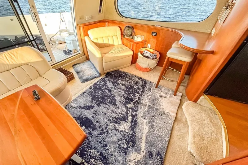 Slide: The Image of Interior of 2003 Silverton 410 Sport Bridge with cozy seating and nautical decor. - 91