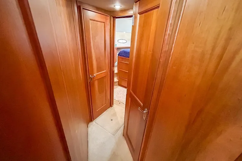 Slide: The Image of Interior hallway of 2003 Silverton 410 Sport Bridge with wooden doors and carpeted floor. - 93