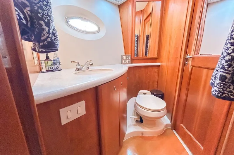Slide: The Image of Luxurious bathroom in 2003 Silverton 410 Sport Bridge yacht with wood accents and modern fixtures. - 97