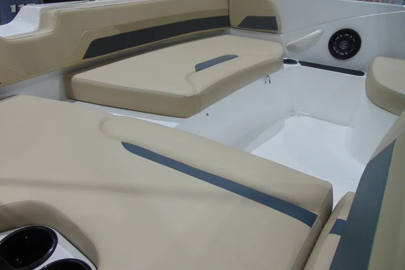 Slide: The Image of 2026 Hurricane SunDeck Sport 185 OB boat interior with beige seating and cup holders. - 11