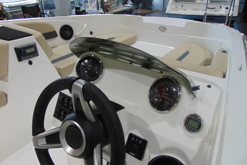 Slide: The Image of 2026 Hurricane SunDeck Sport 185 OB boat interior with steering wheel and dashboard controls. - 12