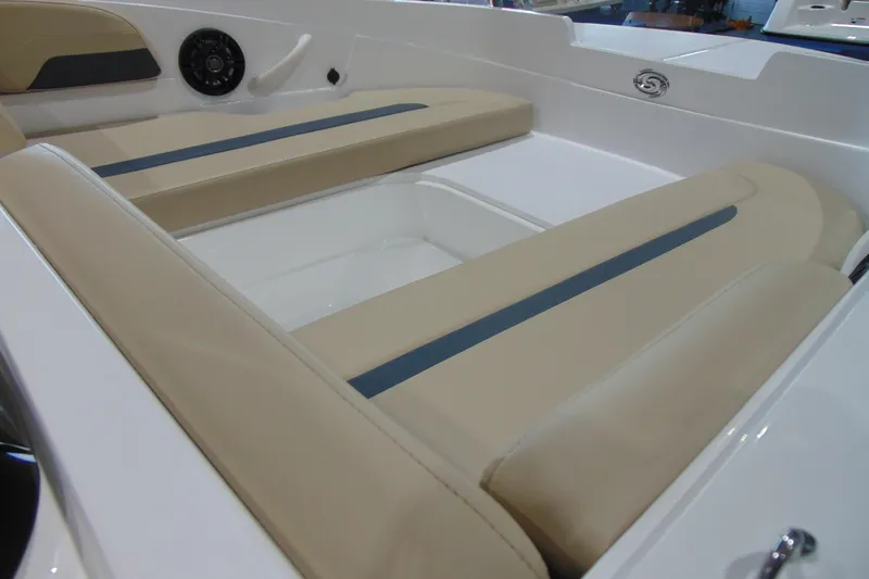 Slide: The Image of 2026 Hurricane SunDeck Sport 185 OB boat interior with beige seating and speaker. - 13