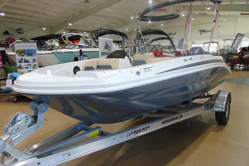 Slide: The Image of 2026 Hurricane SunDeck Sport 185 OB boat displayed indoors on a trailer. - 3