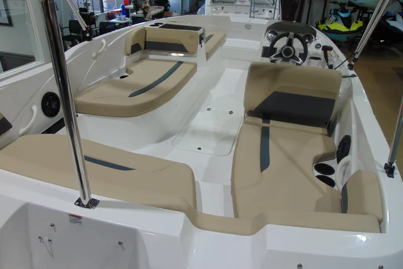 Slide: The Image of 2026 Hurricane SunDeck Sport 185 OB interior with beige seating and steering console. - 7