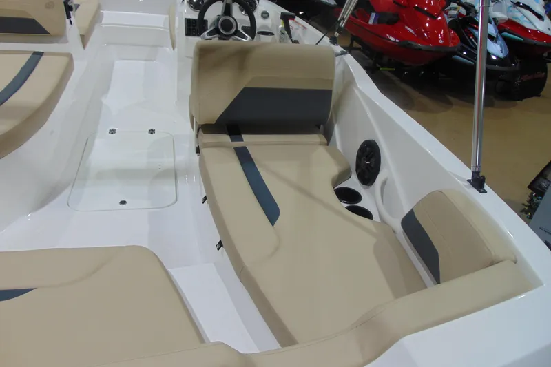 Slide: The Image of 2026 Hurricane SunDeck Sport 185 OB boat interior with beige seating and steering wheel. - 8