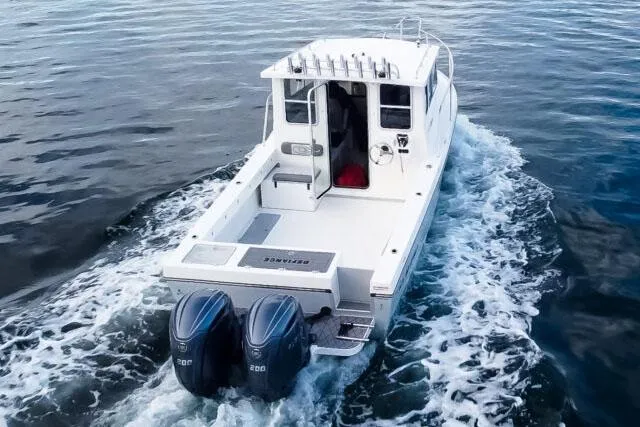 Slide: The Image of Manufacturer Provided Image: 2025 Defiance Admiral 260 EX boat cruising on open water, rear view. - 3