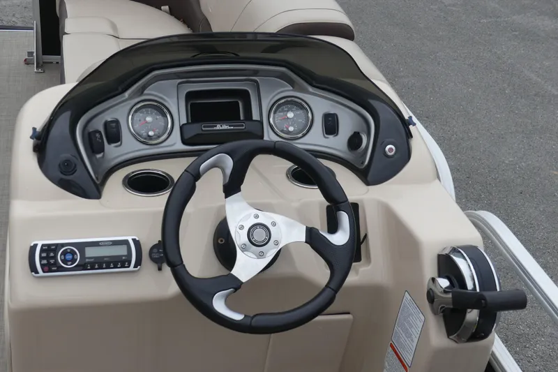 Slide: The Image of 2018 Sun Tracker Party Barge 22 DLX dashboard with steering wheel and controls. - 5
