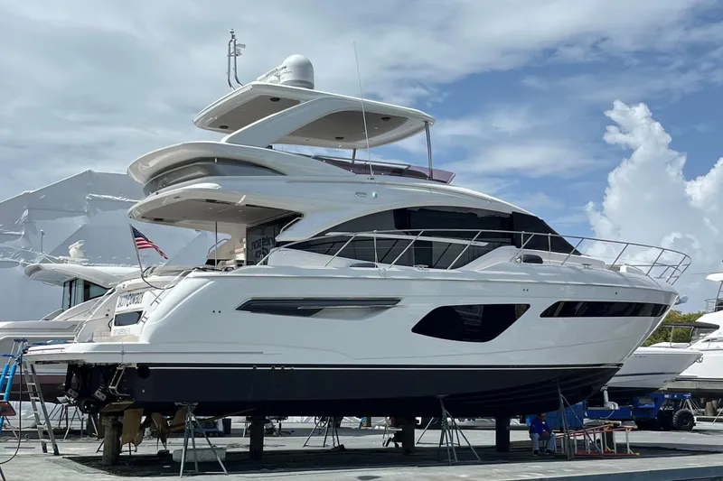 Slide: The Image of 2022 Princess 55 Flybridge yacht on display under a clear blue sky. - 104