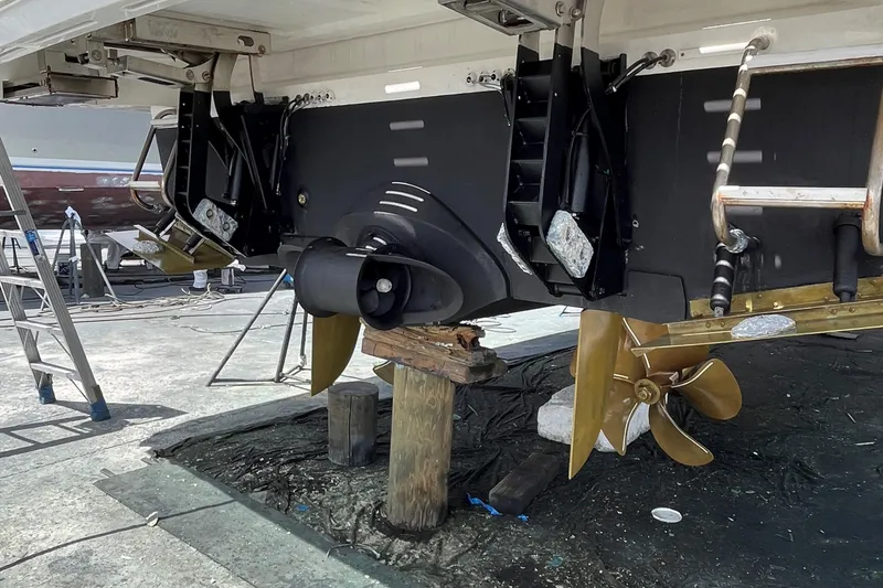 Slide: The Image of 2022 Princess 55 Flybridge yacht under maintenance, showcasing propellers and stern details. - 106