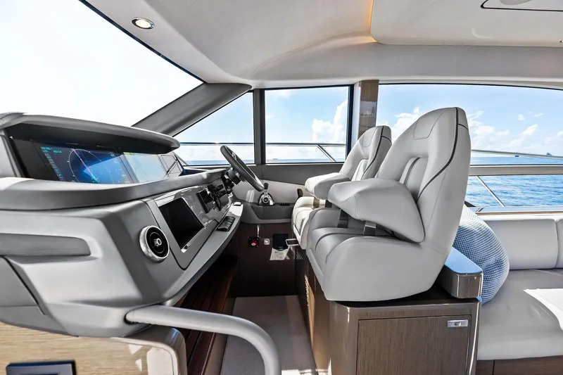 Slide: The Image of Luxurious 2022 Princess 55 Flybridge yacht interior with modern helm and plush seating. - 11