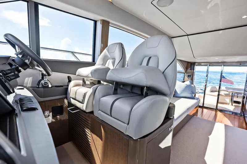 Slide: The Image of Luxurious interior of 2022 Princess 55 Flybridge yacht with modern helm and seating. - 12