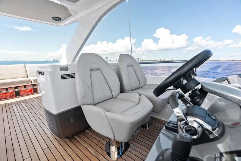 Slide: The Image of Luxurious 2022 Princess 55 flybridge yacht helm with plush seating and ocean view. - 14