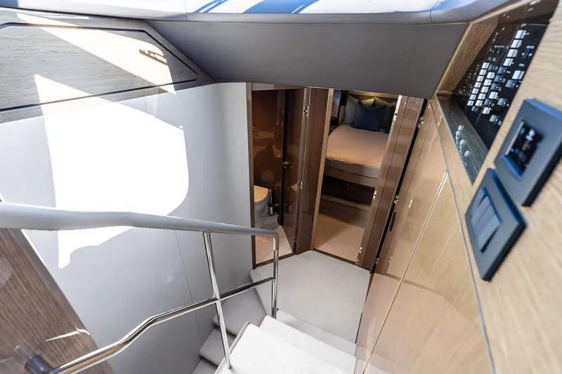 Slide: The Image of Interior view of 2022 Princess 55 Flybridge yacht, featuring modern staircase and luxurious cabin. - 25