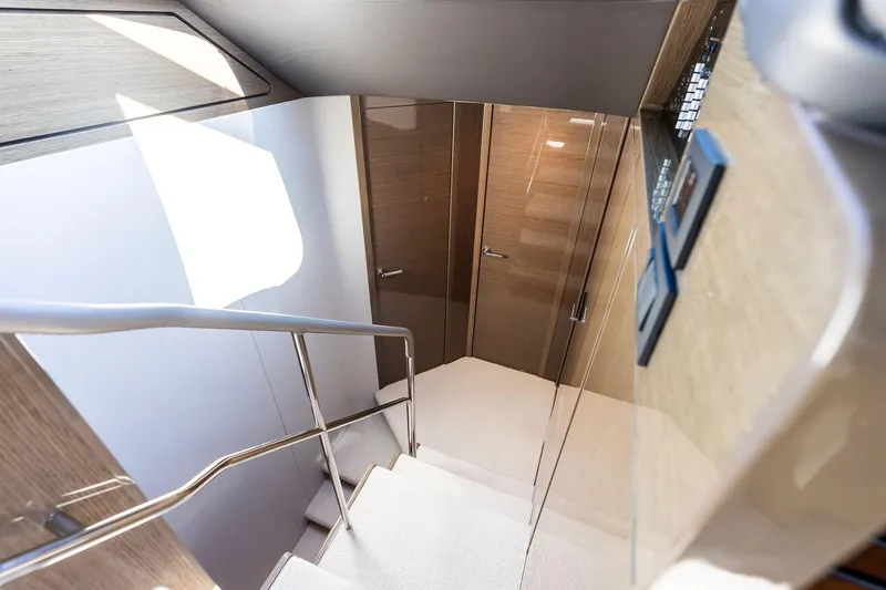 Slide: The Image of Staircase inside 2022 Princess 55 Flybridge yacht with sleek wooden finish and modern design. - 26