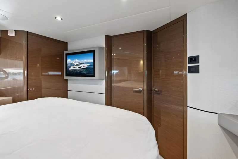 Slide: The Image of Luxurious interior of 2022 Princess 55 Flybridge yacht with modern wood paneling and TV. - 31