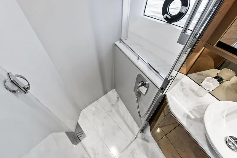 Slide: The Image of Luxurious bathroom interior on 2022 Princess 55 Flybridge yacht, featuring marble surfaces and modern fixtures. - 35