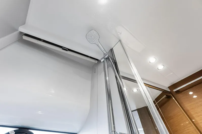 Slide: The Image of Modern shower area in 2022 Princess 55 Flybridge yacht, featuring sleek design and lighting. - 36