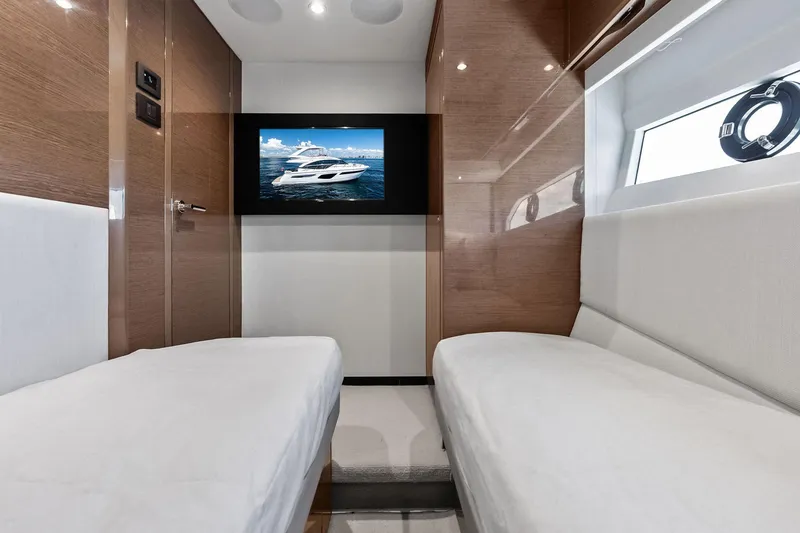 Slide: The Image of Luxurious interior of 2022 Princess 55 Flybridge yacht with twin beds and wall-mounted TV. - 41