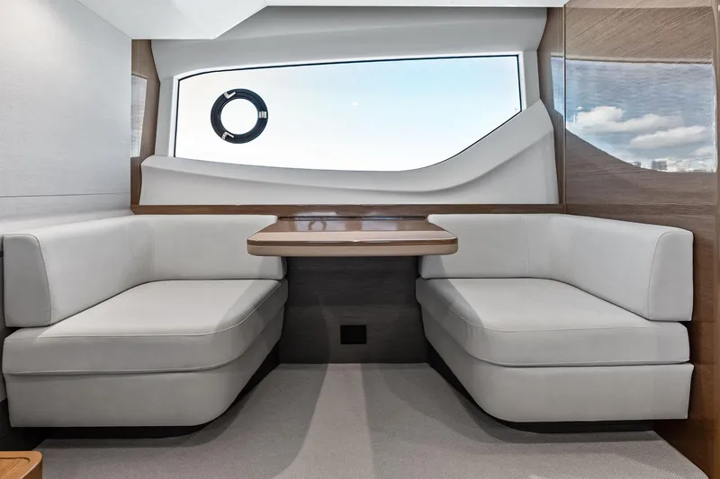 Slide: The Image of Luxurious interior of 2022 Princess 55 Flybridge yacht with elegant seating and large window. - 43