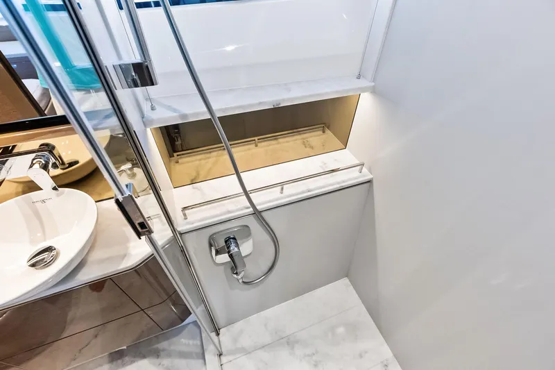 Slide: The Image of Luxurious bathroom interior on 2022 Princess 55 Flybridge yacht, featuring modern fixtures and elegant design. - 45