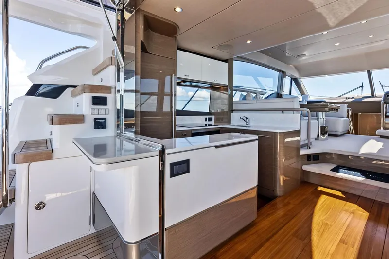 Slide: The Image of Luxurious interior of 2022 Princess 55 Flybridge yacht with modern kitchen and seating area. - 48
