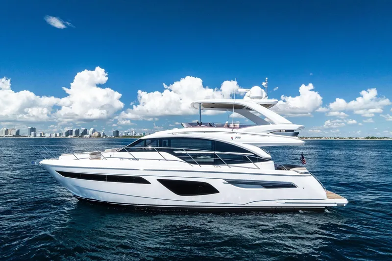 Slide: The Image of 2022 Princess 55 Flybridge yacht cruising on open water under a clear blue sky. - 51