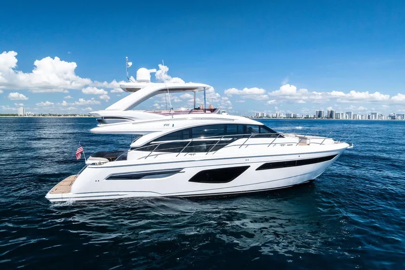 Slide: The Image of 2022 Princess 55 Flybridge yacht cruising on open water under a clear blue sky. - 52