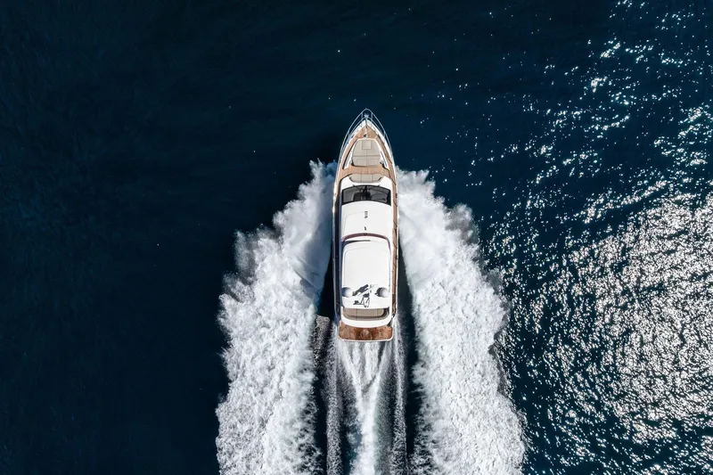 Slide: The Image of Aerial view of 2022 Princess 55 Flybridge yacht cruising on open water. - 59