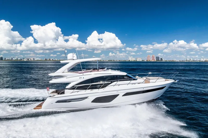 Slide: The Image of 2022 Princess 55 Flybridge yacht cruising on open water under a clear blue sky. - 63