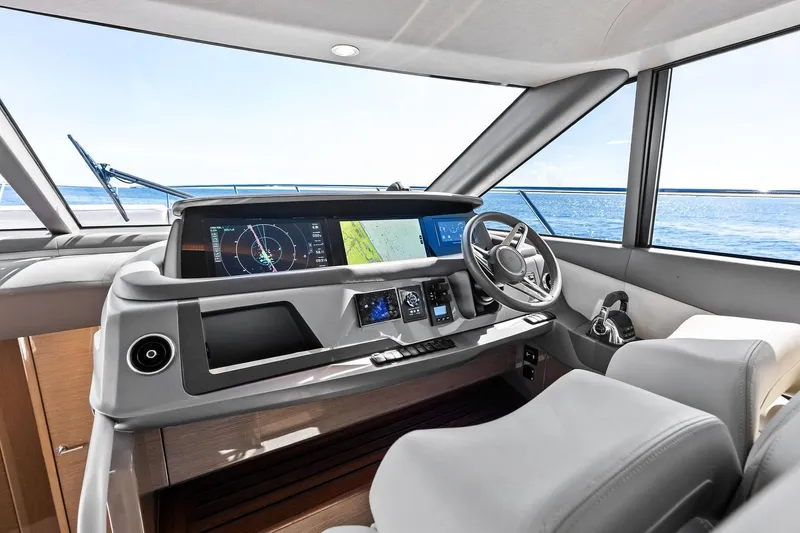 Slide: The Image of Luxurious 2022 Princess 55 Flybridge yacht helm with modern navigation system and ocean view. - 7