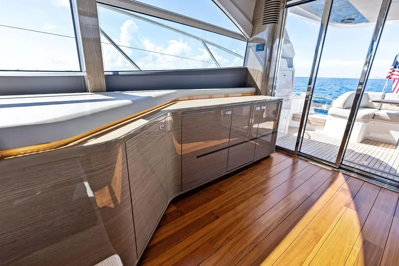 Slide: The Image of Luxurious interior of 2022 Princess 55 Flybridge yacht with ocean view and sleek wood finish. - 74