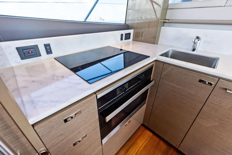 Slide: The Image of Modern kitchen in 2022 Princess 55 Flybridge yacht with sleek appliances and marble countertops. - 76