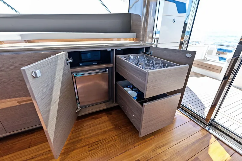 Slide: The Image of Luxurious interior of 2022 Princess 55 Flybridge yacht with open cabinets and drawers. - 79