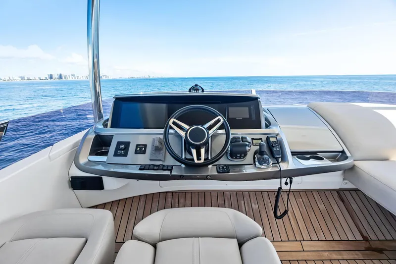 Slide: The Image of Flybridge helm of 2022 Princess 55 yacht with ocean view and modern controls. - 8