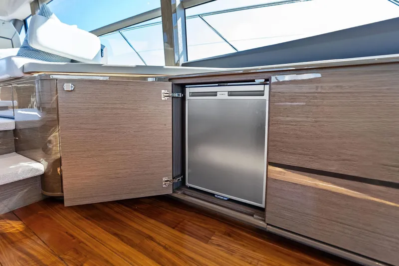 Slide: The Image of Luxurious interior of 2022 Princess 55 Flybridge yacht with sleek cabinetry and built-in fridge. - 80