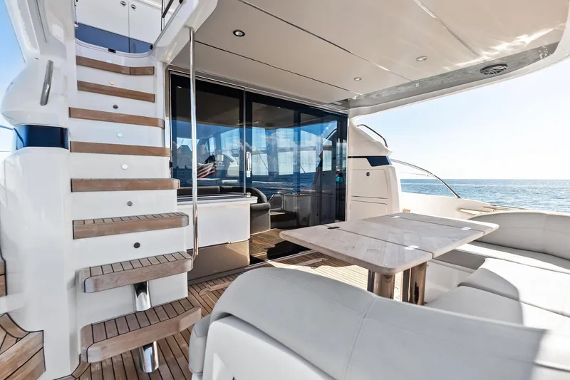 Slide: The Image of Luxurious 2022 Princess 55 Flybridge yacht with elegant outdoor seating and ocean view. - 81