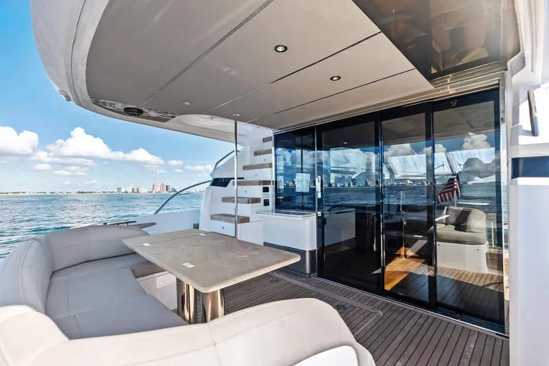 Slide: The Image of Luxurious 2022 Princess 55 Flybridge yacht with elegant outdoor seating and ocean view. - 82
