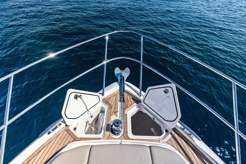 Slide: The Image of Bow view of 2022 Princess 55 Flybridge yacht on open water. - 87