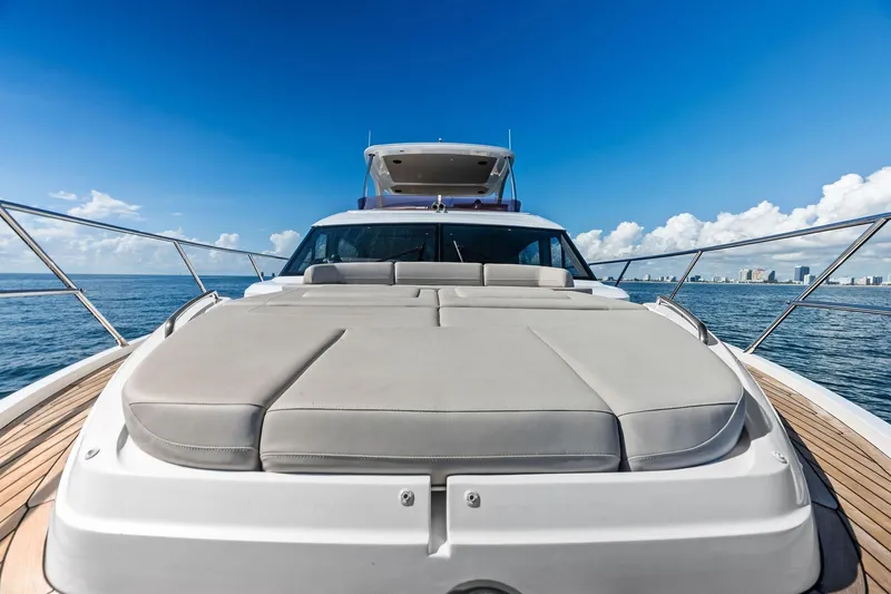 Slide: The Image of Luxurious 2022 Princess 55 flybridge yacht on open sea under clear blue sky. - 89