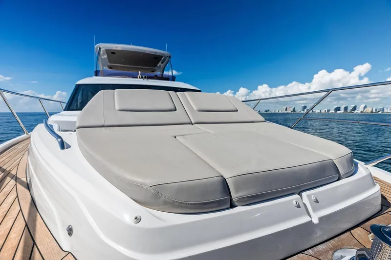 Slide: The Image of 2022 Princess 55 Flybridge yacht with sunbed, cruising on a sunny day. - 91
