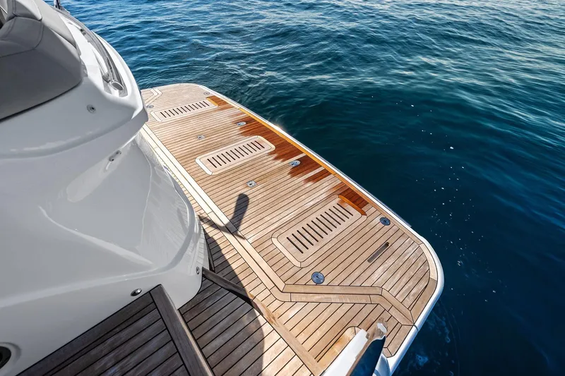 Slide: The Image of Luxury Princess 55 flybridge yacht deck, 2022 model, overlooking serene ocean waters. - 99