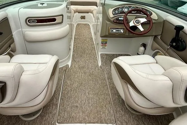 Slide: The Image of 2012 Crownline Eclipse E2 boat interior with beige seating and steering wheel. - 5