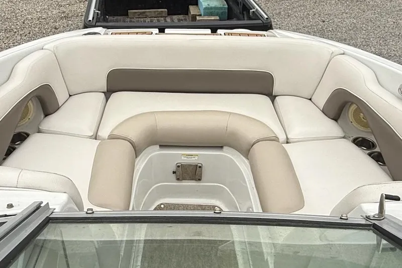 Slide: The Image of 2012 Crownline Eclipse E2 boat interior with beige and white seating arrangement. - 6
