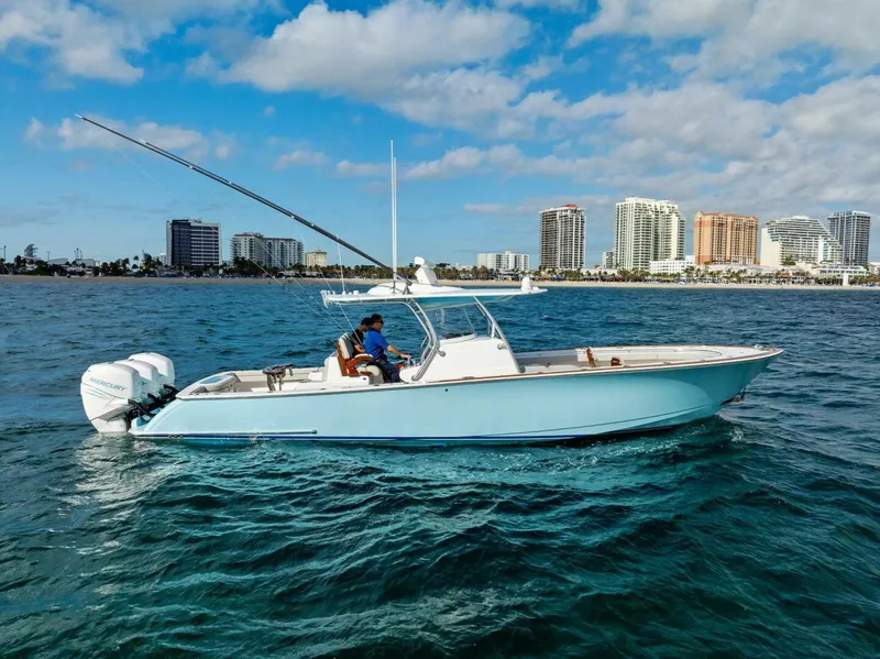 The Image of 2021 Valhalla Boatworks V-37 cruising on water with city skyline in background. - 1
